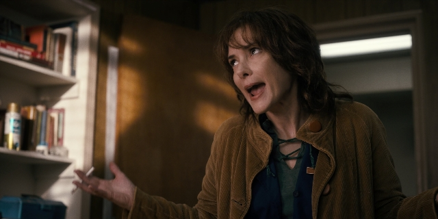 Wide shot frame from Stranger Things — book, standing, room