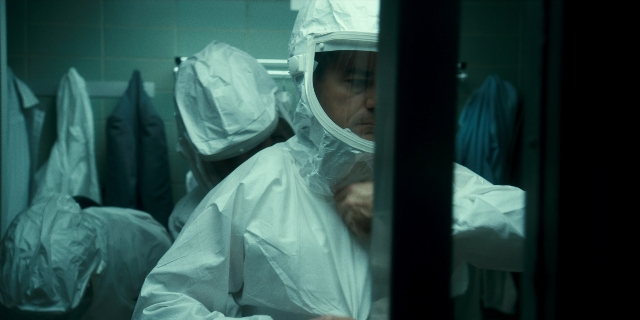 Wide shot frame from Stranger Things — standing, room, suit