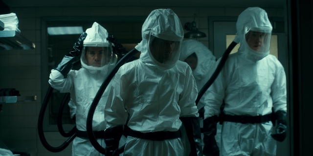 Wide shot frame from Stranger Things — standing, room, suit