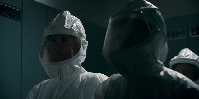 Wide shot frame from Stranger Things — standing, room, suit