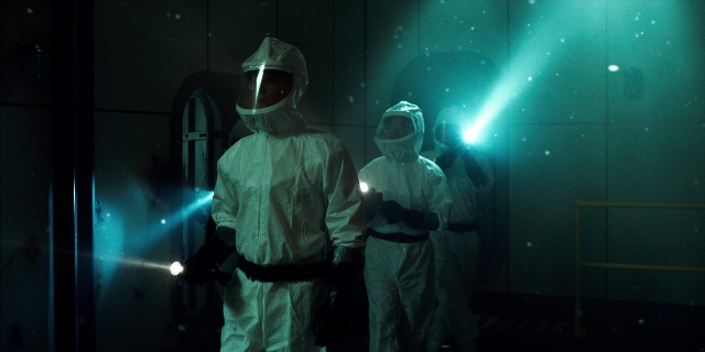 Wide shot frame from Stranger Things — standing, room, door