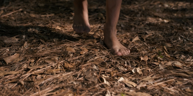 Wide shot frame from Stranger Things — standing, bed, person