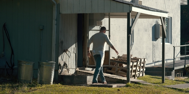 Wide shot frame from Stranger Things — walking, door, hand