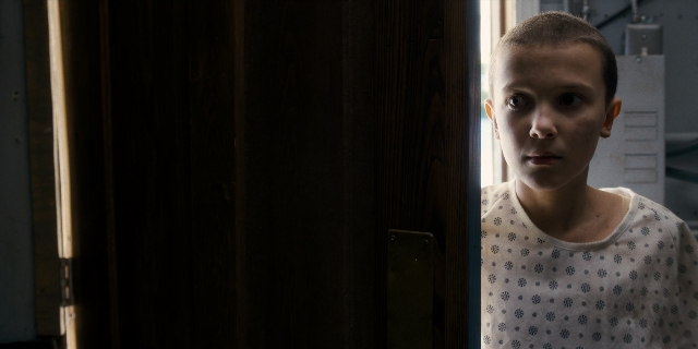 Medium shot frame from Stranger Things — standing, room, door