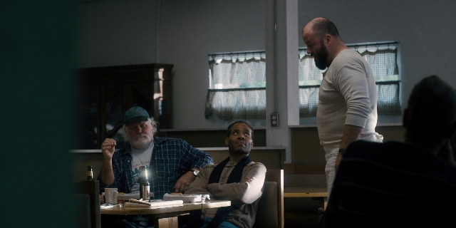 Wide shot frame from Stranger Things — sitting, standing, room
