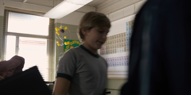 Wide shot frame from Stranger Things — standing, room, shirt