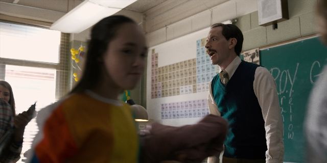 Wide shot frame from Stranger Things — standing, room, shirt