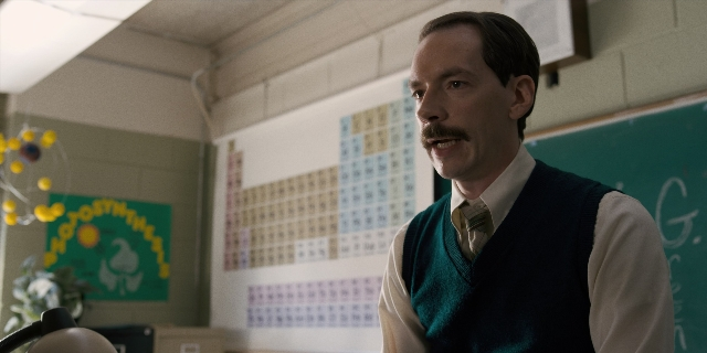 Frame from Stranger Things — standing, room, tie