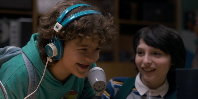 Medium shot frame from Stranger Things — microphone, person, human face