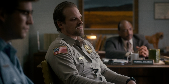 Frame from Stranger Things — sitting, room, uniform