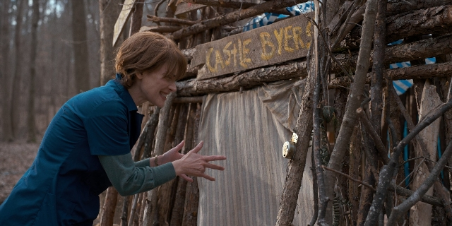 Wide shot frame from Stranger Things — standing, hand, hair