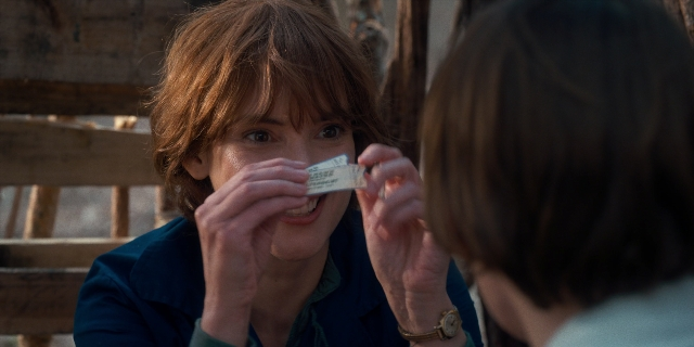 Wide shot frame from Stranger Things — sitting, room, face
