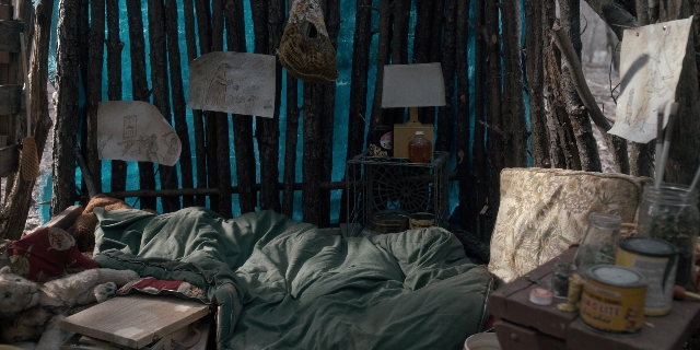 Medium shot frame from Stranger Things — room, table, lamp