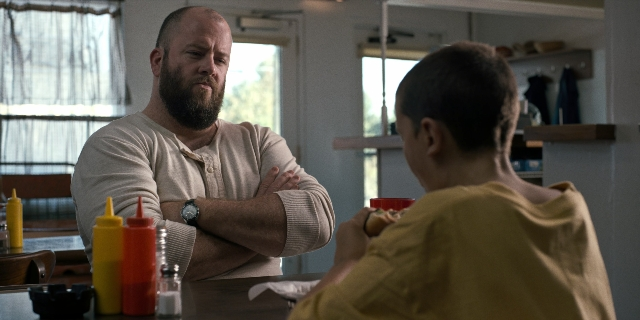 Wide shot frame from Stranger Things — sitting, table, kitchen
