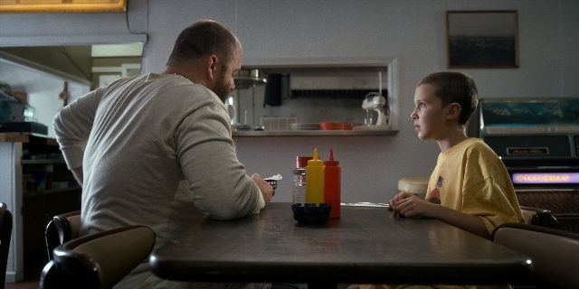 Wide shot frame from Stranger Things — sitting, table, kitchen