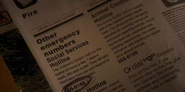 Wide shot frame from Stranger Things — newspaper, poster
