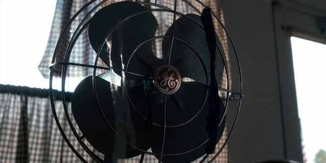 Wide shot frame from Stranger Things — room, window, mechanical fan