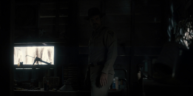 Wide shot frame from Stranger Things — standing, room, hat