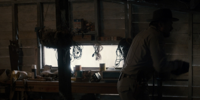 Wide shot frame from Stranger Things — standing, room, table