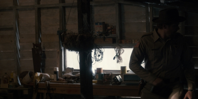 Wide shot frame from Stranger Things — standing, room, phone