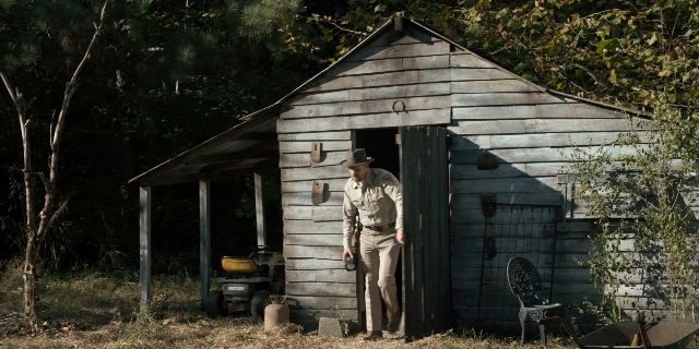 Wide shot frame from Stranger Things — standing, hat, uniform