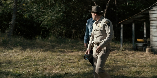Wide shot frame from Stranger Things — walking, hat, uniform