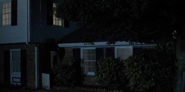Wide shot frame from Stranger Things — door, night, house
