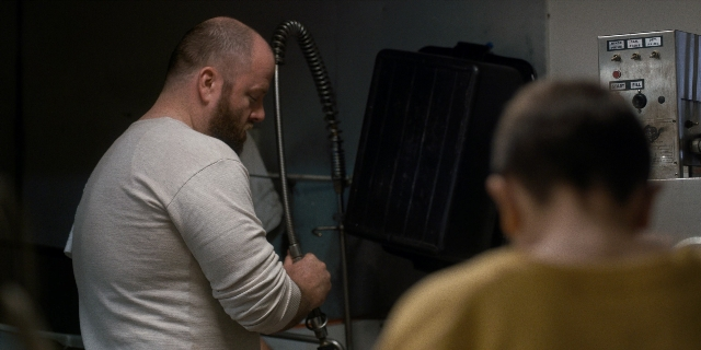 Wide shot frame from Stranger Things — standing, room, shirt