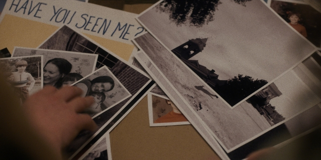 Wide shot frame from Stranger Things — room, hand, person