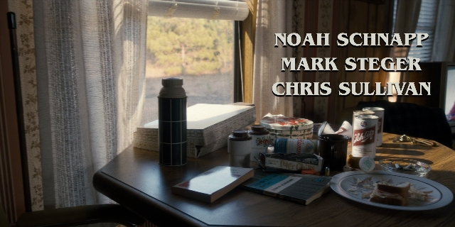 Wide shot frame from Stranger Things — book, plate, table