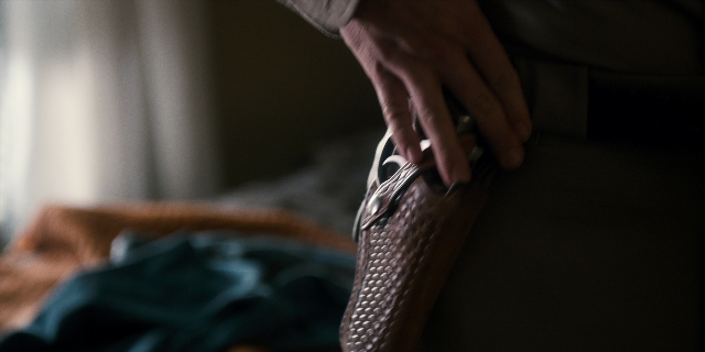 Wide shot frame from Stranger Things — room, hand, bag