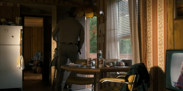 Wide shot frame from Stranger Things — standing, plate, room