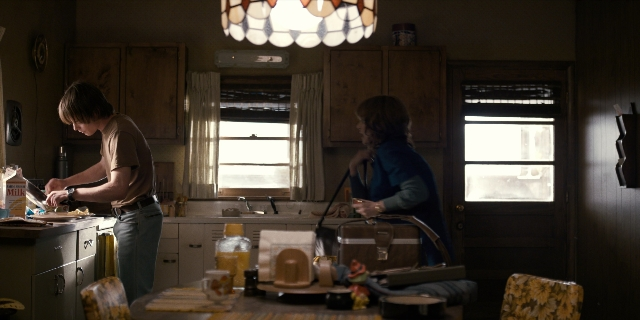 Wide shot frame from Stranger Things — standing, plate, room