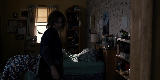 Wide shot frame from Stranger Things — standing, room, bed