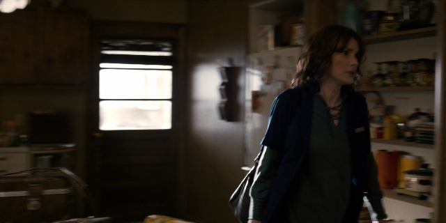 Wide shot frame from Stranger Things — walking, door, kitchen