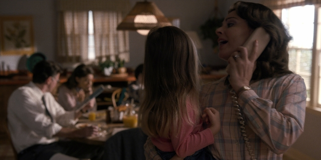 Wide shot frame from Stranger Things — sitting, table, dialogue