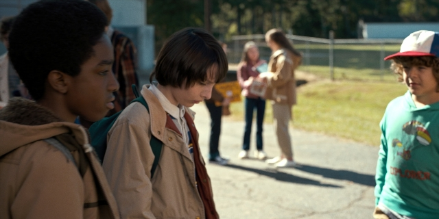 Wide shot frame from Stranger Things — standing, walking, dialogue