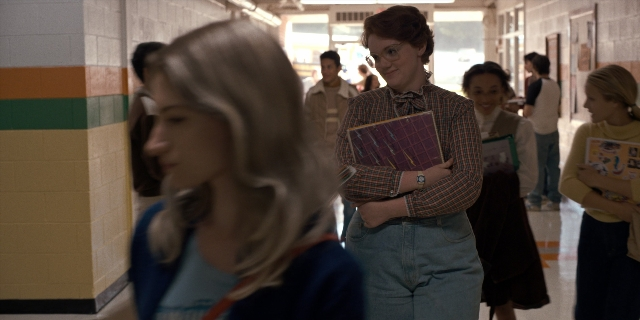 Wide shot frame from Stranger Things — book, standing, walking