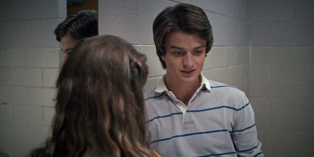 Medium shot frame from Stranger Things — standing, shirt, face