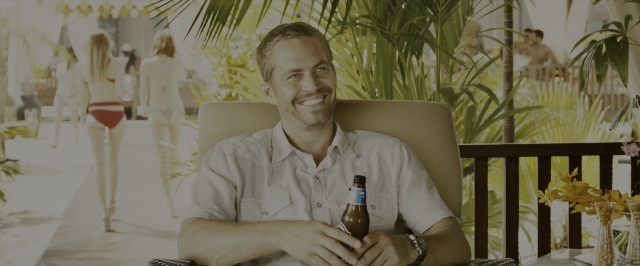 Wide shot frame from Fast & Furious 7 — sitting, walking, hand