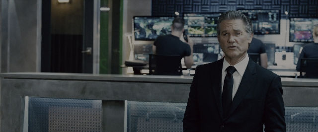 Wide shot frame from Fast & Furious 7 — standing, room, suit