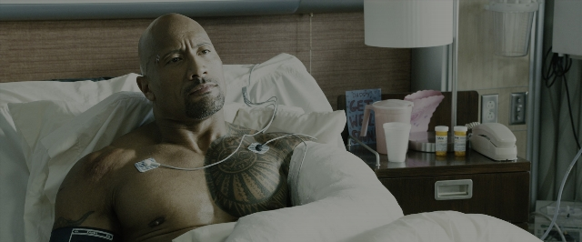 Wide shot frame from Fast & Furious 7 — room, bed, face