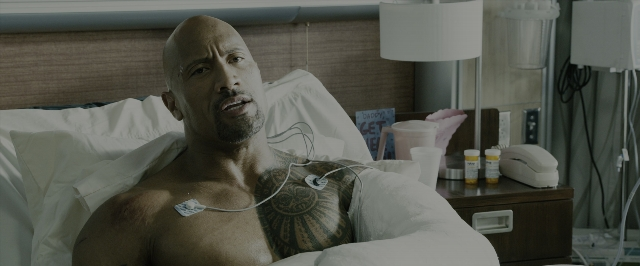 Wide shot frame from Fast & Furious 7 — bed, face, lamp