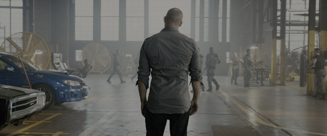 Wide shot frame from Fast & Furious 7 — standing, walking, car