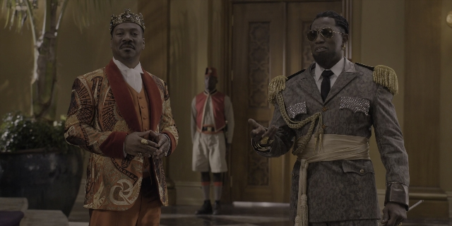 Wide shot frame from Coming 2 America — standing, room, hat