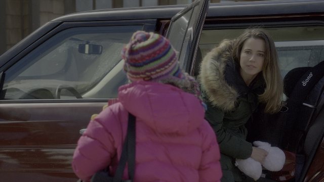 Wide shot frame from Daddy's Home 2 — sitting, phone, street