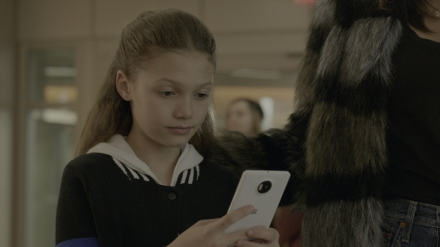 Wide shot frame from Daddy's Home 2 — phone, coat, face