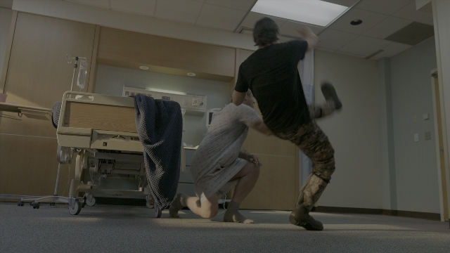 Wide shot frame from Daddy's Home 2 — room, bed, door