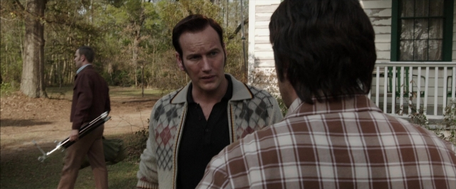 Wide shot frame from The Conjuring — standing, dialogue, shirt