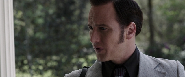 Wide shot frame from The Conjuring — suit, tie, shirt